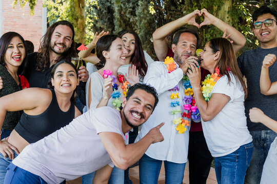 latin family reunion dancing in a party in terrace outdoors in Mexico Latin America. Diverse Hispanic people men and women multi age having fun
