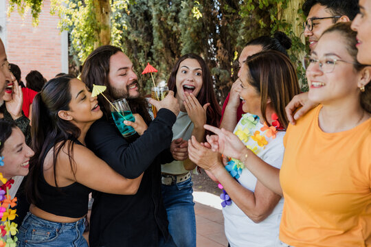 large group of latin friends dancing in a party in terrace outdoors in Mexico Latin America. Diverse Hispanic people men and women multi age having fun