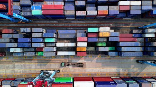 Jakarta, Indonesia - 18 July 2026: Aerial view of Port of Tanjung Priok with rows of colorful shipping containers and industrial port infrastructure.