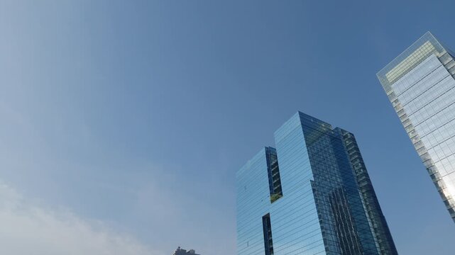 Modern glass office buildings stand in Kowloon Bay July 12 2026