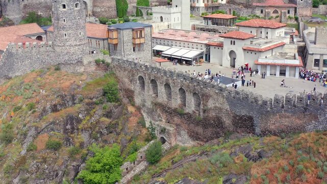 Rabati Castle rises beneath ascending aerial view above stone towers, courtyards and fortified terraces in Akhaltsikhe, supporting museum tourism, historic architecture and Georgian travel media.