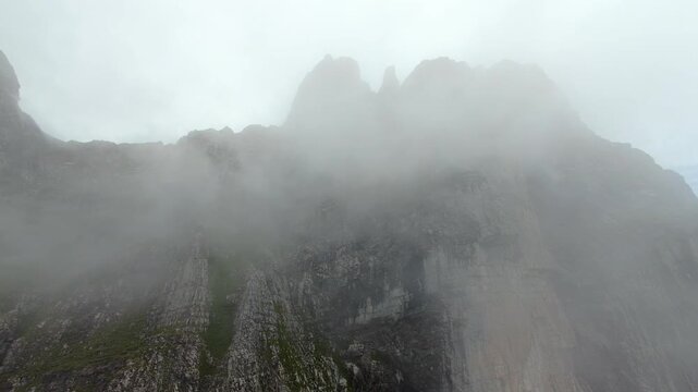 FPV Drone Flight Through Clouds Toward Swiss Mountain Cliffs