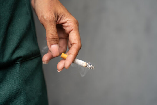 Close-up image of a woman smoking outdoors.