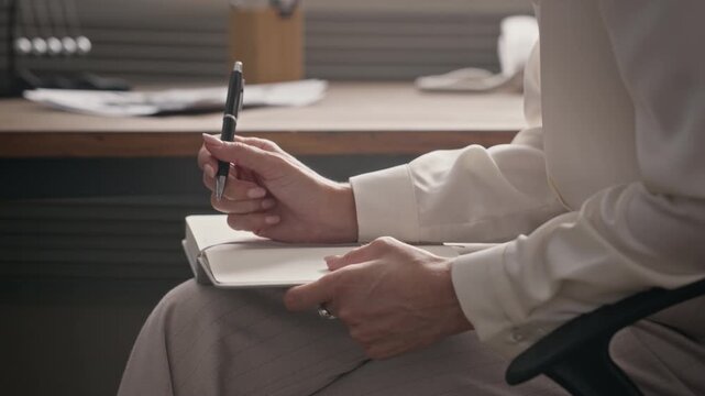 Middle-aged Caucasian man speaking during therapy session with female psychologist taking notes in notebook. Footage is perfect for mental health awareness campaigns and counseling services