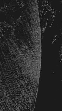 Abstract high-contrast monochrome image showing diagonal striations and curved grainy texture on black background, scientific microscopic appearance with wispy fiber-like lines.