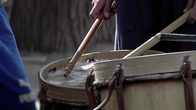 Close Up of Wooden Mallets Beating Rawhide Drumhead on Bombo Leguero - 4K