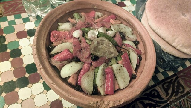 Traditional Moroccan Tagine with Garlic Cloves and Flatbread