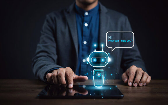 Businessman interacting with glowing blue chatbot hologram on digital tablet in dark studio setting for tech support.