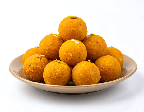 
plate of laddu, laddoo or ladoo isolated white background, popular traditional Indian sweet treats made during festivals, religious ceremonies and celebrations