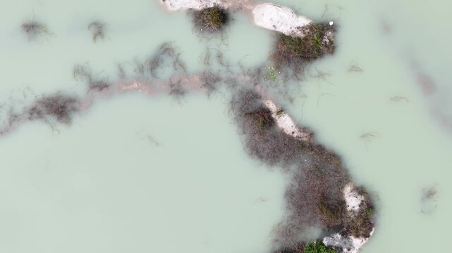 Kaolin Lake is an artificial lake formed from a former kaolin mining area. This lake is famous for its turquoise blue water which contrasts sharply with the white soil deposits around it.
