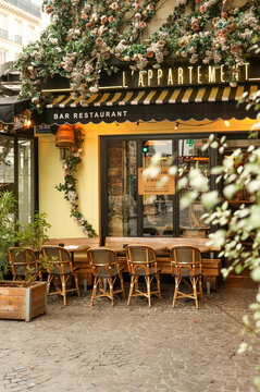 Paris, France. October 13, 2025. Paris cafe bar restaurant with outdoor seating and floral decoration