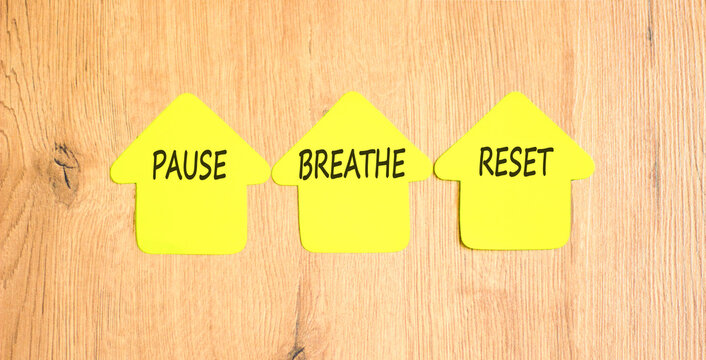 Pause breathe reset symbol. Concept words Pause breathe reset on beautiful yellow paper houses. Beautiful wooden background. Business support motivational and pause breathe reset concept. Copy space.