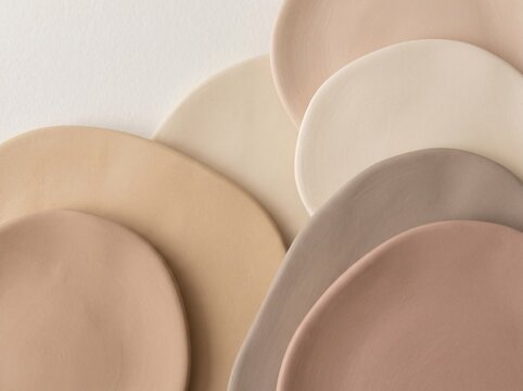 Abstract nude color palette background. Soft beige and tan ceramic shapes composition.