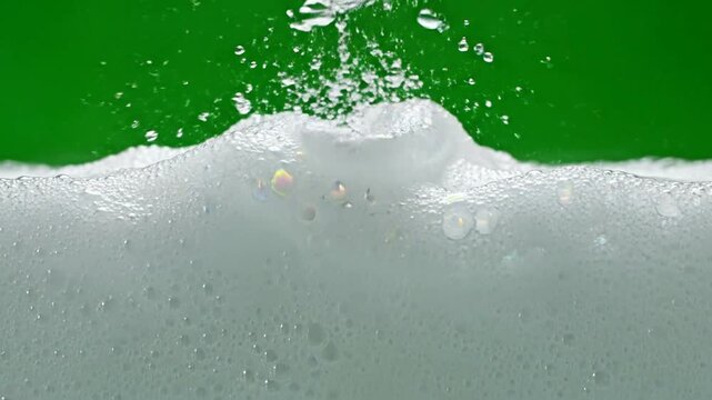 White soap foam bubbles splashing on green screen background, for cosmetic product, overlay lather