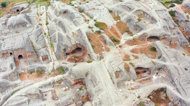 Uplistsikhe terraces unfold beneath overhead aerial view across carved rooms, stairways and erosion patterns, supporting site mapping, archaeology education and long-term conservation planning.