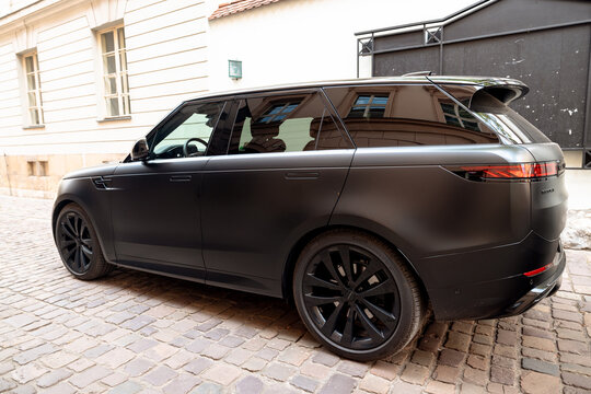 Krakow, Poland - July 19, 2026: Matte black Range Rover Sport parked on a cobblestone street in Krakow, Poland.