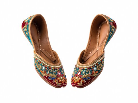 Pair of traditional Indian jutti shoes featuring vibrant velvet fabric with intricate floral embroidery, beads, and mirror work, isolated on a white background for ethnic fashion displays.