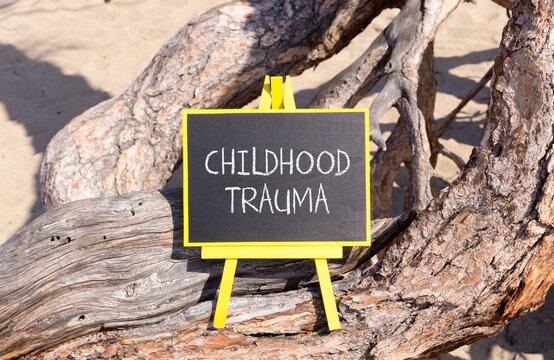 Childhood trauma words symbol. Concept words Childhood trauma on beautiful black blackboard. Beautiful old tree background. Psychological childhood trauma support concept. Copy space.