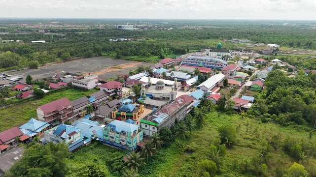 Aerial view of an Islamic boarding school with a large mosque inside