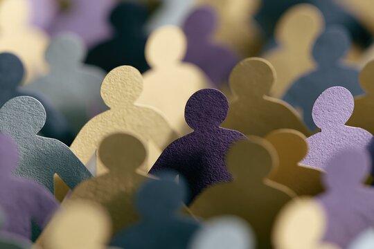 Shallow depth of field paper people figurines in pastel and muted tones representing inclusion for poster and background use