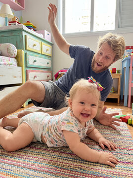 Father and baby playing together