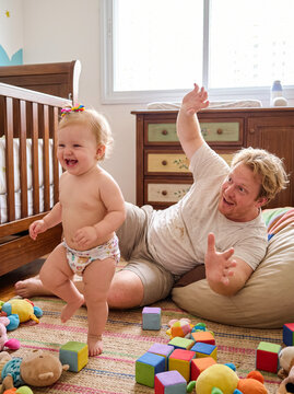 Baby laughing with father playtime