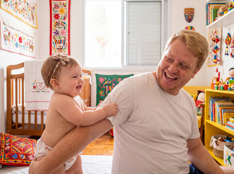 Baby pulling father arm