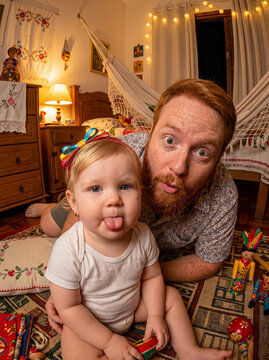 Father and baby making faces