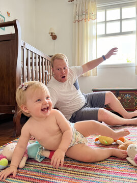 Father and baby laughing