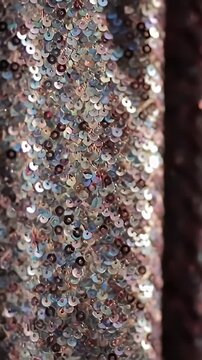 Shimmering rose gold and silver sequin fabric close up