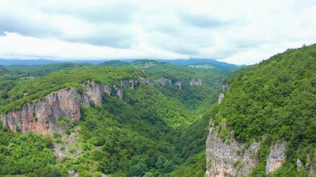 Katskhi canyon stretches across aerial view between limestone cliffs and remote forest valleys near Chiatura, supporting nature tourism, geology education, hiking media and regional travel promotion.