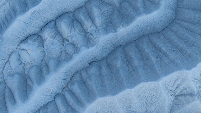 Aerial view of the intricate eroded ridges and deep gullies of the badlands landscape in the desert terrain Hanksville, Utah, United States.