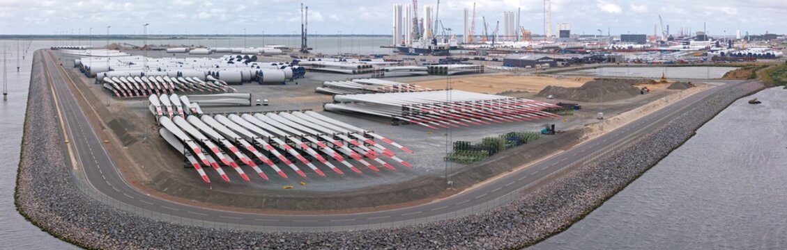 Esbjerg, Denmark - 24 July 2026: Aerial view of Esbjerg Port with rows of Vestas wind turbine blades and mast elements stored on the ground, waiting for transport to offshore wind farms.