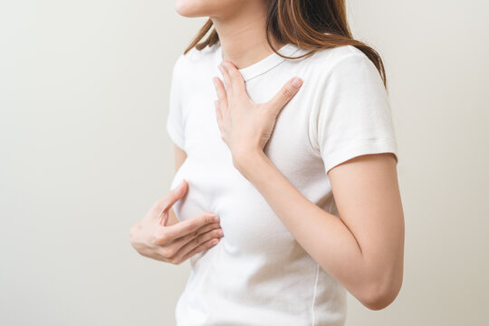 Acid reflux disease, suffer asian young woman have symptom gastroesophageal, esophageal, stomach ache and heartburn pain hand on chest from digestion problem after eat food, Healthcare medical concept