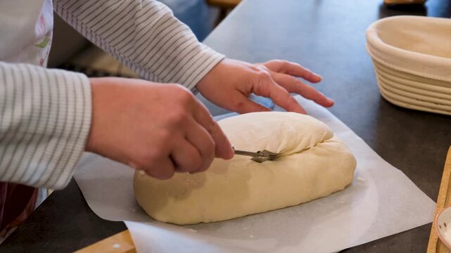 Fresh Yeast Dough Being Scored Before Oven Baking