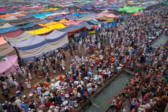 Tongi, Dhaka Division, Bangladesh - 31 January 2025: Aerial view of the Bishwa Ijtema at Tongi Ijtema Maidan, with colorful tents and crowds of people near a water channel.