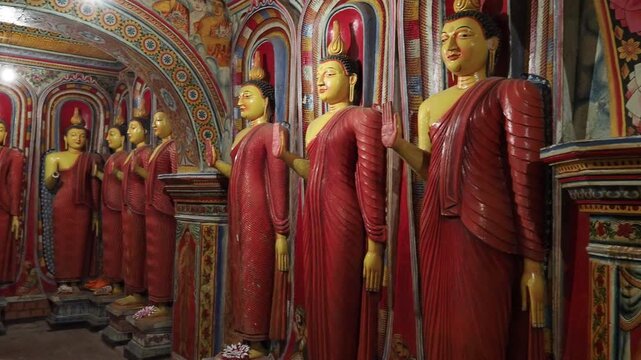 Row of buddha statues inside temple in Sri Lanka
