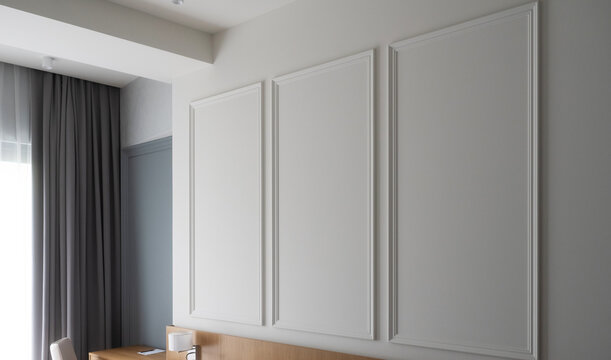 Room featuring decorative white wall paneling, a wooden headboard, dark grey curtains, and a bright window creating a modern, clean, and minimalist interior design