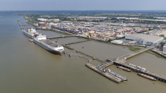 Purfleet-on-Thames, United Kingdom - 10 July 2026: Aerial view of Purfleet Container terminal with cargo ships docked at the pier, shipping containers, and industrial facilities.