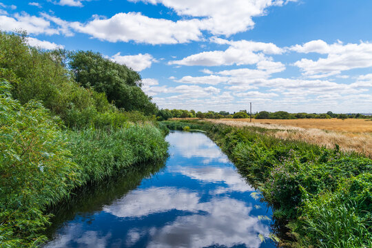 Reflections of the clouds in the sky in the River Anker on a beautiful Summer day