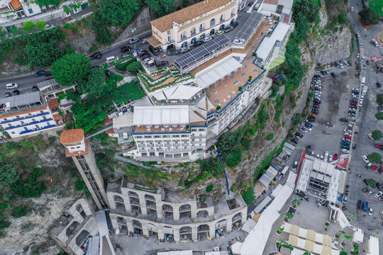 Sorrento, Italy - 24 July 2026: Aerial view of Hotel Bellevue Syrene perched on the cliffside with its iconic elevator tower, expansive terraces, and surrounding coastal landscape in Campania, Italy.