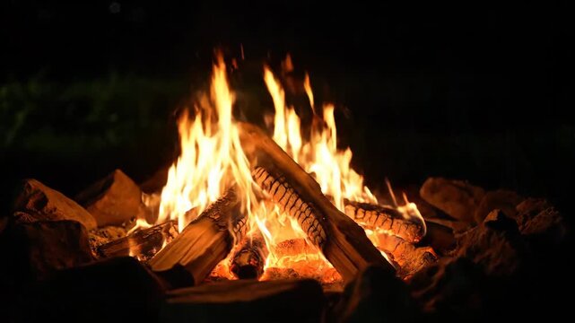 Bright Orange Flames Burning Brightly in a Nighttime Campfire Setting