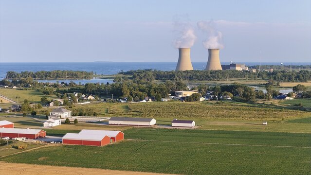 Frenchtown Township, United States - 24 July 2026: Aerial view of Enrico Fermi II NPP with cooling towers emitting steam, situated on the shore of Lake Erie, surrounded by farmland.
