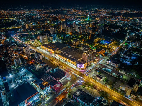 Santiago de los Caballeros, Santiago, Dominican Republic - 29 December 2025: Aerial view of Agora Santiago Center illuminated at night, surrounded by vibrant city lights and urban landscape.