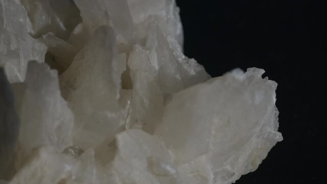 A sample of white gypsum crystals isolated on a black background