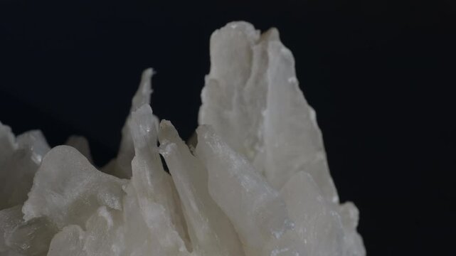 A sample of white gypsum crystals isolated on a black background