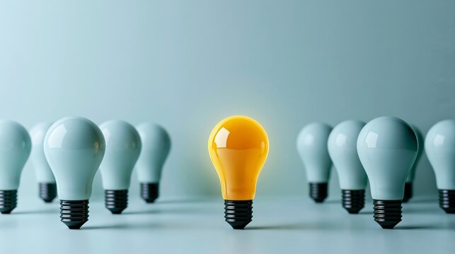 Glowing yellow light bulb illuminating among many deactivated blue bulbs, representing outstanding unique idea and innovation