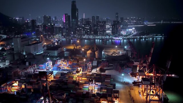 Unloading large cargo containers seaport. Loading freight sea port. Top aerial drone view. Lot big boxes rows, ship delivery ocean harbor. Shipping night. Goods export import. Industrial Marine dock.