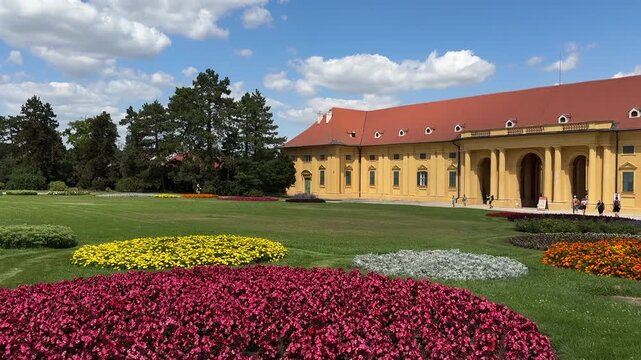 Colorful flower beds decorate the formal gardens of Lednice Castle in the Czech Republic under a bright summer sky. Historic palace, cultural heritage, sightseeing, tourism and scenic European travel 