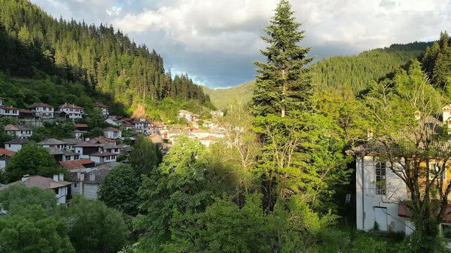 Drone Reveal Above Traditional House Unveiling Shiroka Laka Village at Golden Hour, Bulgaria